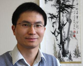 Portrait of Prof. Liming Zhang, guest speaker, with a Chinese scroll in the backgroun