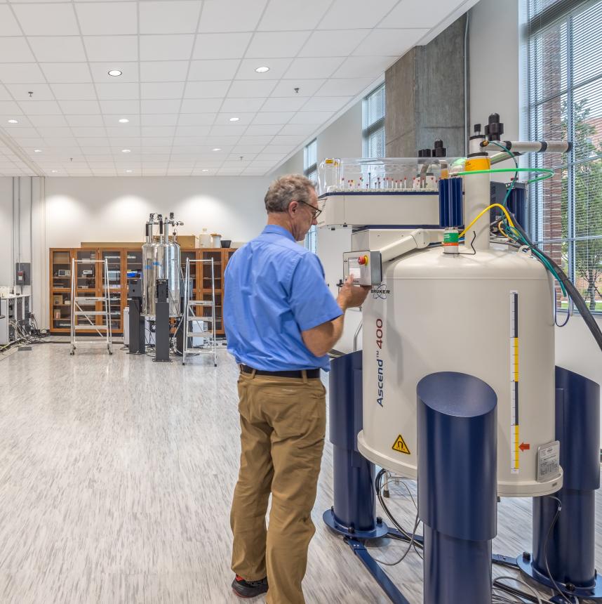 Picture of Dr. Earle Adams, NMR Facility manager, working with NMR equipment in the lab