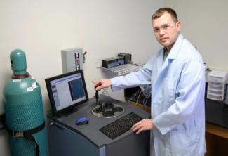 Standing in a lab where researchers have tested a new way to administer cancer fighting drugs by use of a weak magnetic field