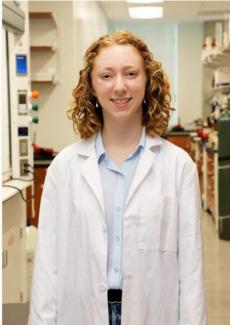 Portrait of Audrey Conner, Goldwater Scholar, with an organic chemistry lab in the background