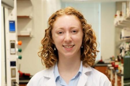 Portrait of Audrey Conner, Goldwater Scholar, with an organic chemistry lab in the background