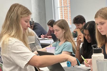 Image of Chemistry Learning Assistant working with students in a CHEM 1211 class