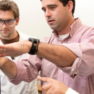 Faculty and Chemistry Graduate Students working in Laboratory|Chemistry Ph.D. student Evan White, left to right, talks with professor Jason Locklin and fellow Chemistry Ph.D. student Anandi Roy about an experiment on a m...