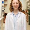 Portrait of Audrey Conner, Goldwater Scholar, with an organic chemistry lab in the background