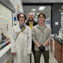 High school student Copper Callahan, science teacher Robert Pulliam, and UGA Chemistry graduate student Skyler Hollers stand in an organic chemistry lab with fume hood and lab bench in the background