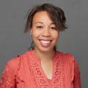 Head shot of Prof. Kensha Clark, African-American woman wearing reddish-orange blouse