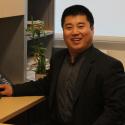 Photo of Dr. Chengshan Wang, speaker, seated at his desk