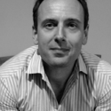 Black-and-white head shot of Prof. Sherburn, dark-haired caucasian man wearing a striped shirt